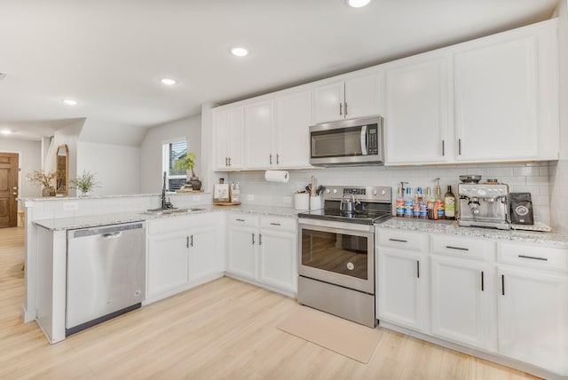 1802 Arcola Ct, Forney, TX 75126 - kitchen with appliances with stainless steel finishes, a sink, a peninsula, white cabinets, and backsplash