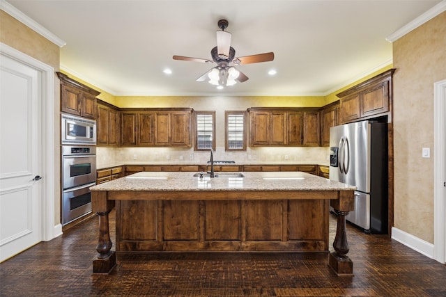 1270 Timber Ln, Frisco, TX 75036 - kitchen featuring stainless steel appliances, a sink, a breakfast bar area, an island with sink, and crown molding