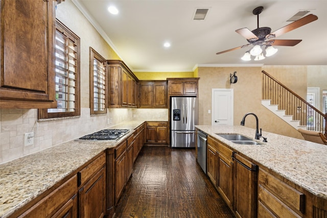 1270 Timber Ln, Frisco, TX 75036 - kitchen featuring stainless steel appliances, a sink, dark wood finished floors, light stone counters, and a ceiling fan