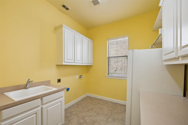 1270 Timber Ln, Frisco, TX 75036 - laundry area featuring hookup for an electric dryer, hookup for a washing machine, cabinet space, baseboards, and light tile patterned floors