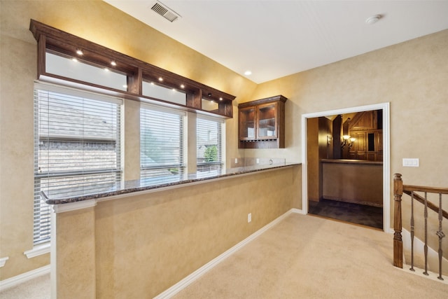 1270 Timber Ln, Frisco, TX 75036 - kitchen with carpet, stone countertops, glass insert cabinets, and baseboards
