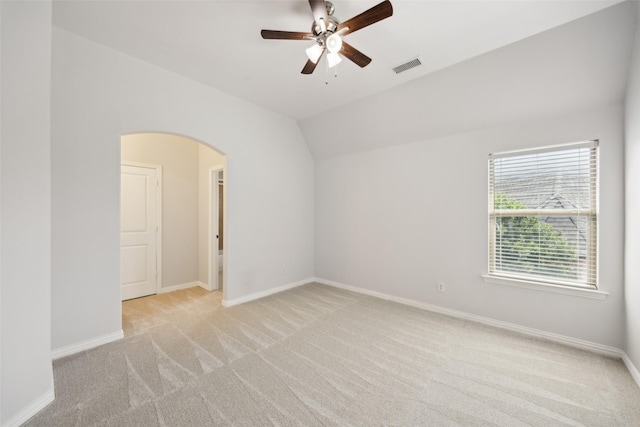 1270 Timber Ln, Frisco, TX 75036 - spare room with arched walkways, light carpet, vaulted ceiling, a ceiling fan, and baseboards