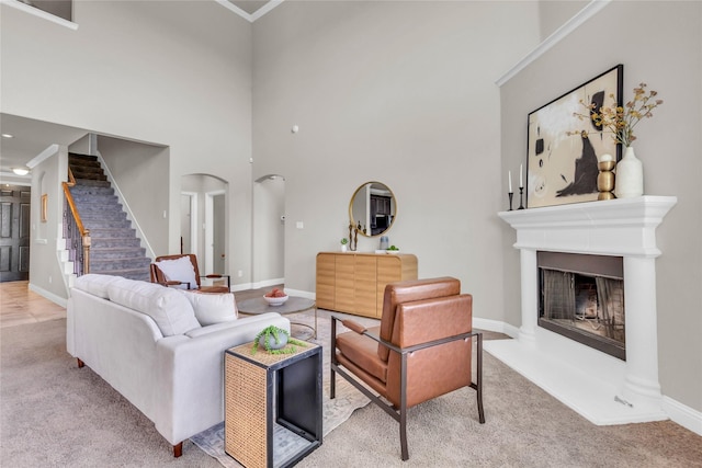 405 Calvert Dr, Midlothian, TX 76065 - living room featuring stairs, carpet flooring, a towering ceiling, ornamental molding, and baseboards