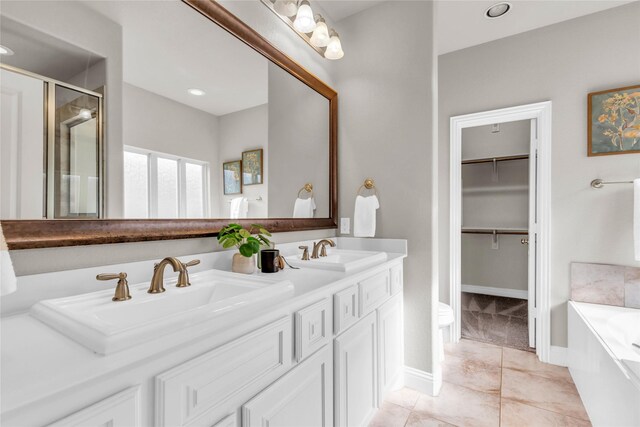 405 Calvert Dr, Midlothian, TX 76065 - full bath with a stall shower, a garden tub, double vanity, a spacious closet, and baseboards