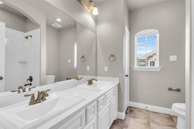 405 Calvert Dr, Midlothian, TX 76065 - bathroom with toilet, baseboards, a shower, and double vanity