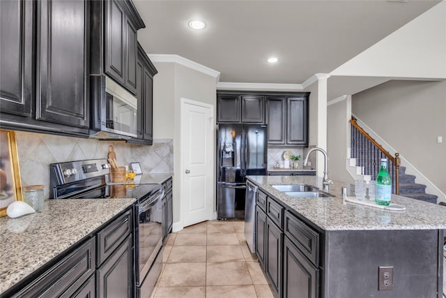 405 Calvert Dr, Midlothian, TX 76065 - kitchen with appliances with stainless steel finishes, a sink, light stone countertops, a center island with sink, and tasteful backsplash