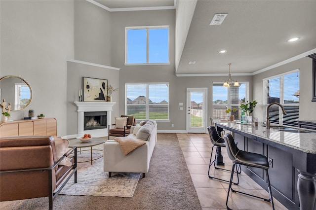 405 Calvert Dr, Midlothian, TX 76065 - living room featuring ornamental molding, a fireplace, baseboards, plenty of natural light, and light tile patterned flooring