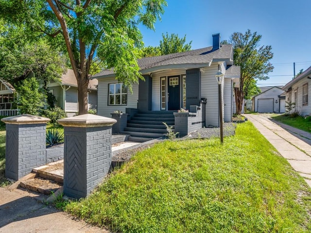 809 Cristler Ave, Dallas, TX 75223 - view of front of home with a chimney, a front lawn, and roof with shingles