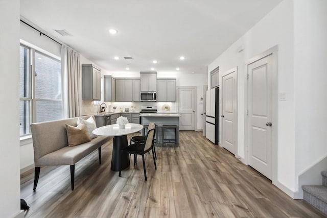 615 Arapaho Dr, Plano, TX 75075 - dining room with light wood-style flooring and recessed lighting