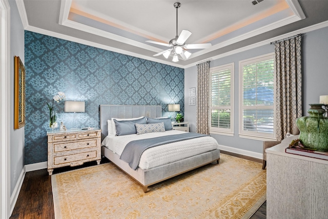 903 Crescent Dr, Highland Village, TX 75077 - bedroom featuring a raised ceiling, dark wood-style flooring, crown molding, baseboards, and ceiling fan