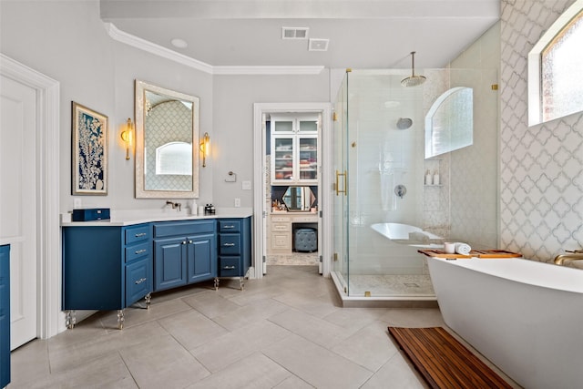 903 Crescent Dr, Highland Village, TX 75077 - full bath with a stall shower, vanity, tile patterned flooring, crown molding, and a freestanding tub