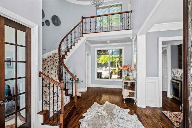 903 Crescent Dr, Highland Village, TX 75077 - foyer featuring wood finished floors, stairs, a high ceiling, ornamental molding, and a chandelier