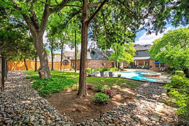 903 Crescent Dr, Highland Village, TX 75077 - fenced backyard with an in-ground hot tub and a patio area