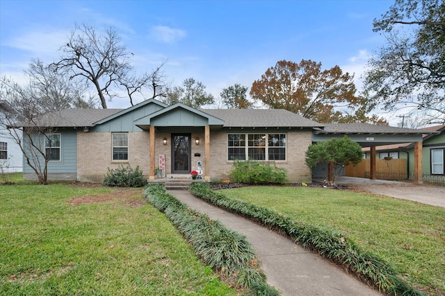 1817 Woodlawn Ave, Corsicana, TX 75110 - ranch-style house with brick siding, concrete driveway, a front lawn, a carport, and board and batten siding