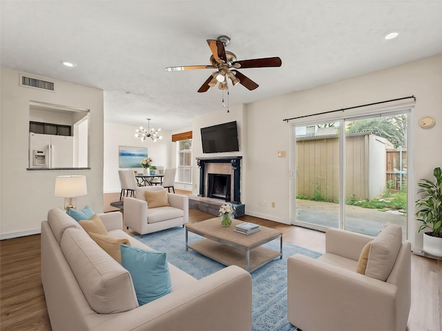 12605 Burninglog Ln, Dallas, TX 75243 - living room featuring wood finished floors, baseboards, a ceiling fan, recessed lighting, and a chandelier