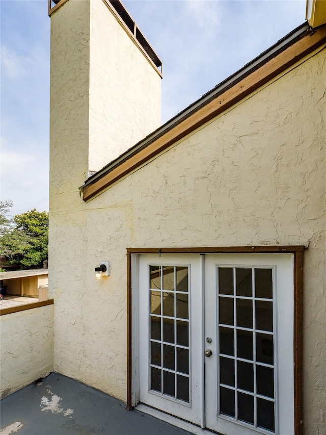 12605 Burninglog Ln, Dallas, TX 75243 - entrance to property featuring stucco siding and french doors