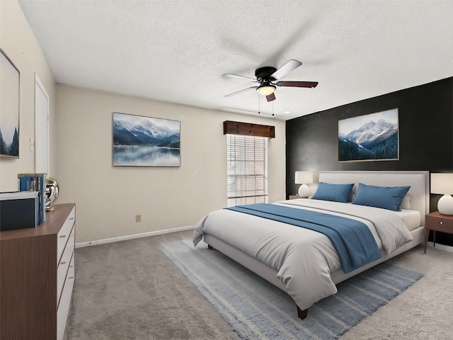 12605 Burninglog Ln, Dallas, TX 75243 - carpeted bedroom featuring a textured ceiling, baseboards, and ceiling fan
