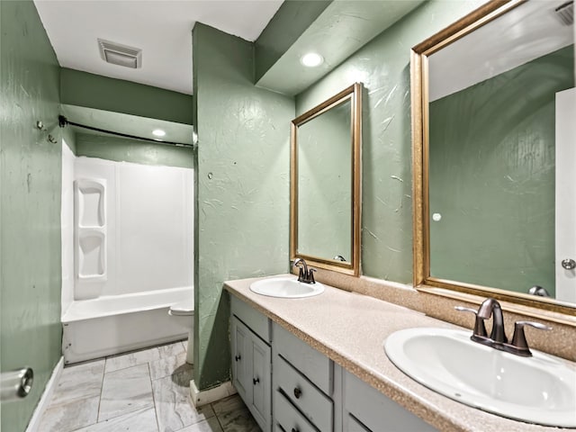 12605 Burninglog Ln, Dallas, TX 75243 - bathroom featuring double vanity, marble finish floors, and tub / shower combination