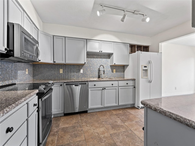12605 Burninglog Ln, Dallas, TX 75243 - kitchen with stainless steel appliances, a sink, tasteful backsplash, and dark stone counters