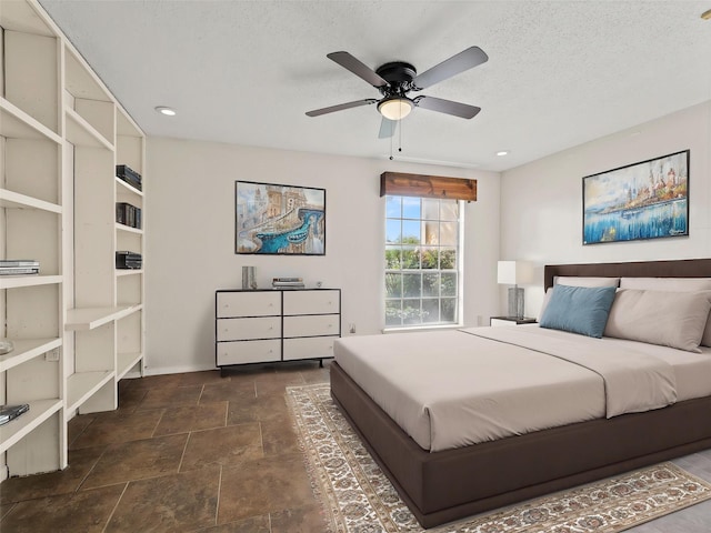 12605 Burninglog Ln, Dallas, TX 75243 - bedroom with dark stone finish floors, a textured ceiling, ceiling fan, baseboards, and recessed lighting