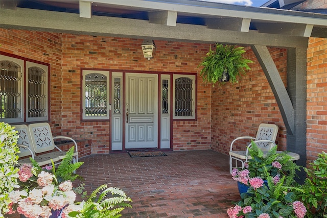 4549 Walnut Hill Ln, Dallas, TX 75229 - view of exterior entry featuring brick siding and covered porch