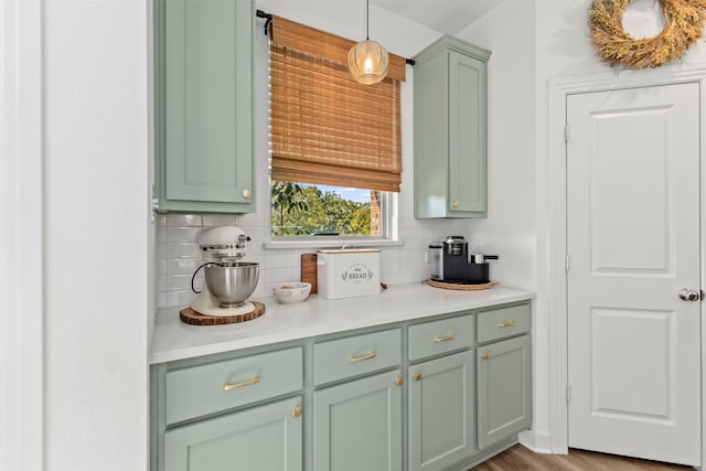 3942 Oak Crk, Denison, TX 75020 - kitchen with green cabinetry, decorative backsplash, light countertops, and hanging light fixtures