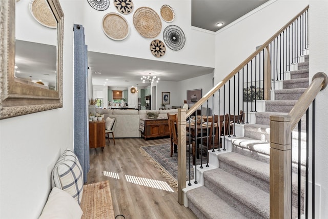 3942 Oak Crk, Denison, TX 75020 - entryway with wood finished floors, stairway, a chandelier, a high ceiling, and recessed lighting