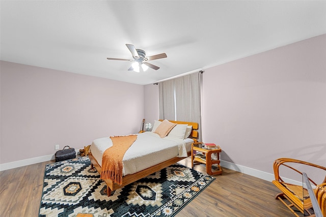 8400 Hickory St Unit 103, Frisco, TX 75034 - bedroom featuring baseboards, wood finished floors, and a ceiling fan
