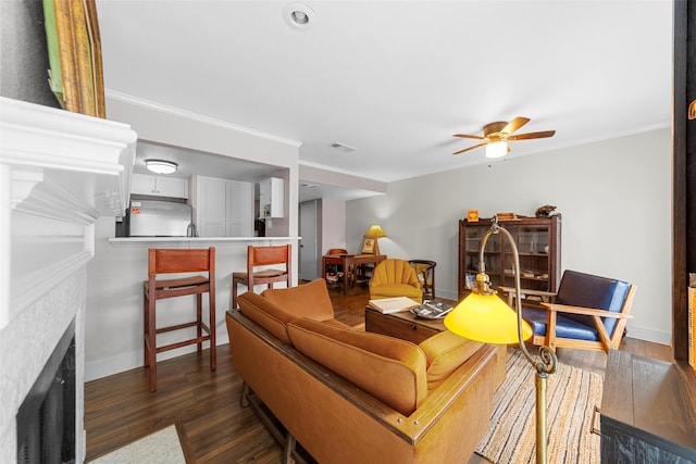8400 Hickory St Unit 103, Frisco, TX 75034 - living area with a fireplace with flush hearth, a ceiling fan, wood finished floors, baseboards, and ornamental molding