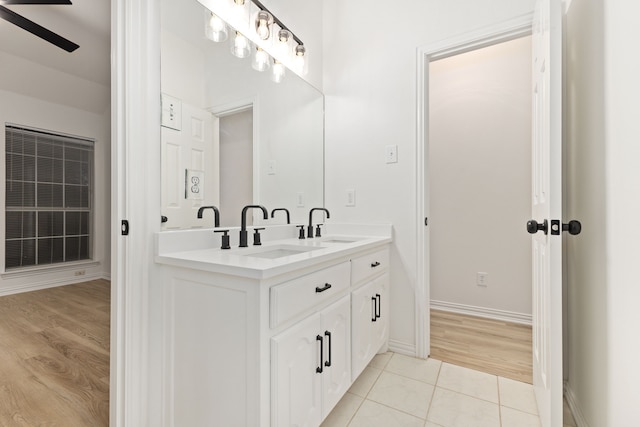1275 Shores Blvd, Rockwall, TX 75087 - bathroom with double vanity, ceiling fan, wood finished floors, and baseboards