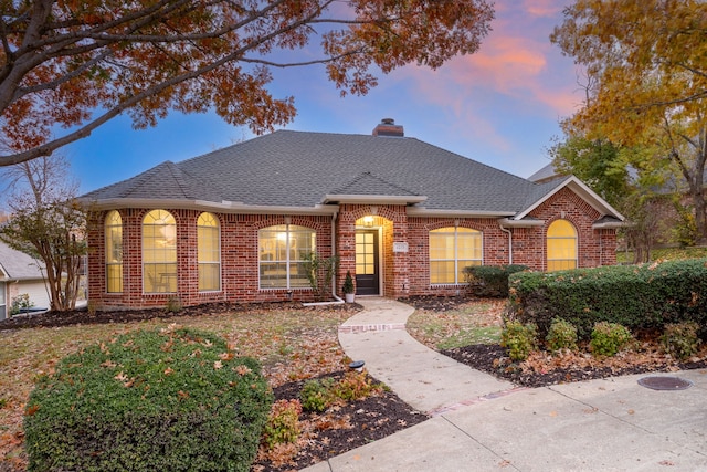 1275 Shores Blvd, Rockwall, TX 75087 - traditional-style house featuring brick siding, a shingled roof, and a chimney