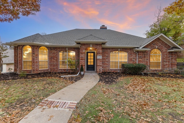 1275 Shores Blvd, Rockwall, TX 75087 - view of front of home featuring brick siding, a chimney, and roof with shingles