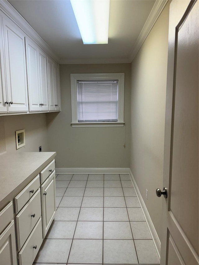 5714 Ferrell Dr, Shreveport, LA 71129 - laundry area featuring light tile patterned floors, washer hookup, cabinet space, crown molding, and baseboards