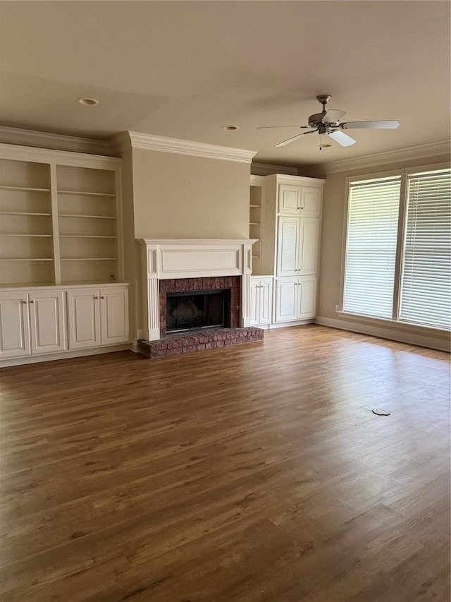 5714 Ferrell Dr, Shreveport, LA 71129 - unfurnished living room with crown molding, wood finished floors, a brick fireplace, ceiling fan, and built in features