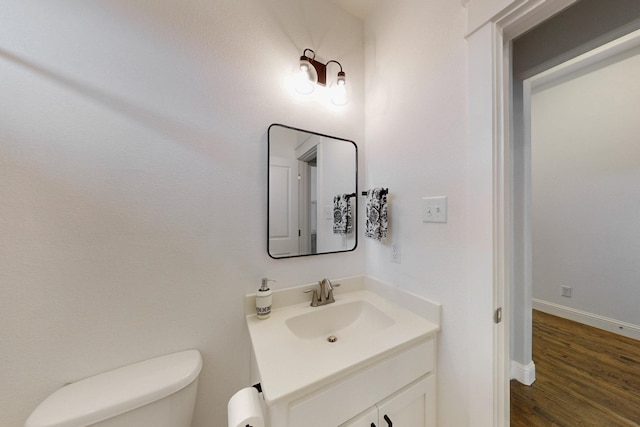 3716 Alder Dr, Mckinney, TX 75071 - bathroom featuring toilet, vanity, wood finished floors, and baseboards