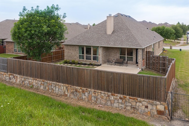 3716 Alder Dr, Mckinney, TX 75071 - rear view of property featuring brick siding, a chimney, a shingled roof, and a patio
