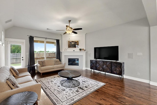 3716 Alder Dr, Mckinney, TX 75071 - living room featuring a large fireplace, dark wood-type flooring, a ceiling fan, lofted ceiling, and baseboards