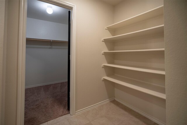 1543 Meadowlake Dr, Waxahachie, TX 75165 - walk in closet featuring light tile patterned flooring