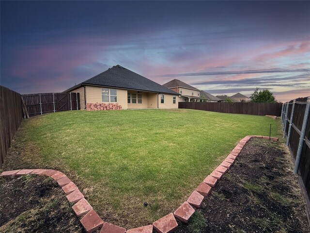 1543 Meadowlake Dr, Waxahachie, TX 75165 - back of house at dusk featuring a shingled roof