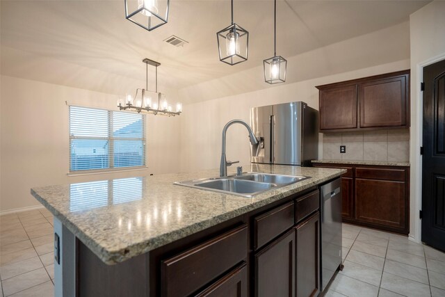 1543 Meadowlake Dr, Waxahachie, TX 75165 - kitchen featuring a sink, appliances with stainless steel finishes, light tile patterned flooring, an island with sink, and dark brown cabinetry