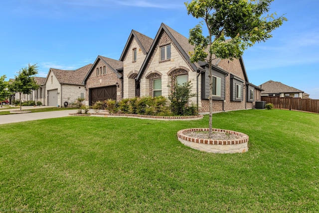 2139 Devonblue Dr, Forney, TX 75126 - view of front of house with stone siding, driveway, a garage, brick siding, and central AC unit