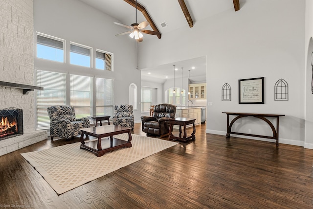 2139 Devonblue Dr, Forney, TX 75126 - living room featuring a stone fireplace, a ceiling fan, high vaulted ceiling, dark wood-type flooring, and beam ceiling