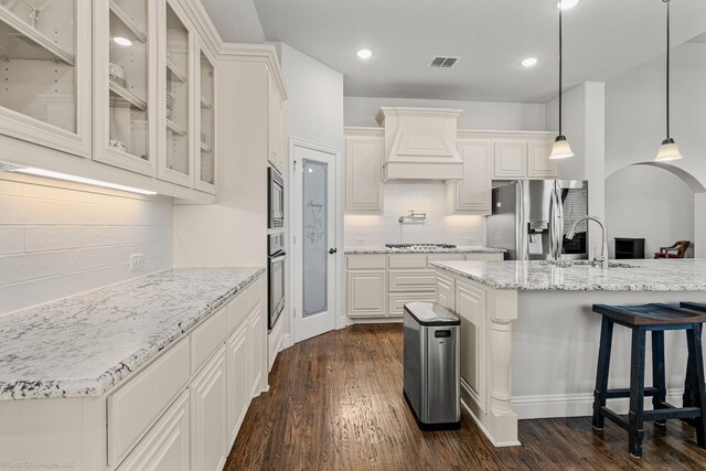 2139 Devonblue Dr, Forney, TX 75126 - kitchen featuring stainless steel appliances, custom range hood, tasteful backsplash, a sink, and dark wood finished floors