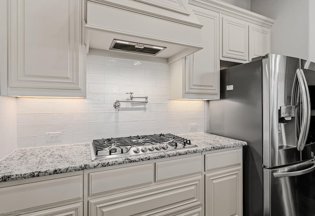 2139 Devonblue Dr, Forney, TX 75126 - kitchen featuring stainless steel appliances, backsplash, white cabinetry, and light stone countertops