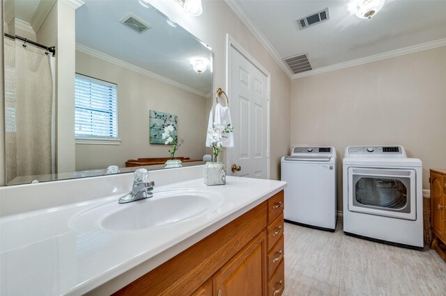 1096 Cedar Oak Dr, Pottsboro, TX 75076 - bathroom featuring separate washer and dryer, crown molding, vanity, and wood finished floors