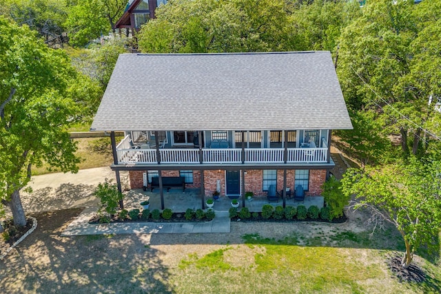 1096 Cedar Oak Dr, Pottsboro, TX 75076 - view of front of house featuring roof with shingles, a balcony, a patio area, and brick siding