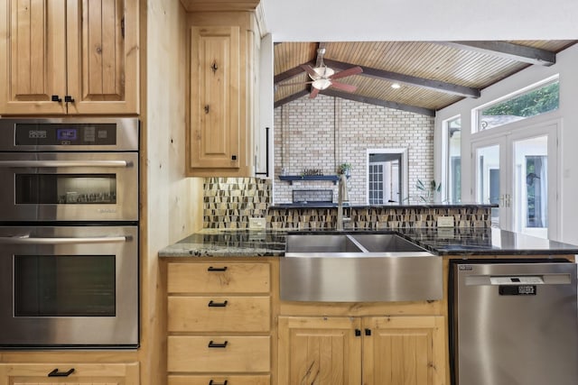 8820 Hunters Glen Trl, Fort Worth, TX 76120 - kitchen with appliances with stainless steel finishes, light brown cabinetry, a sink, a ceiling fan, and tasteful backsplash