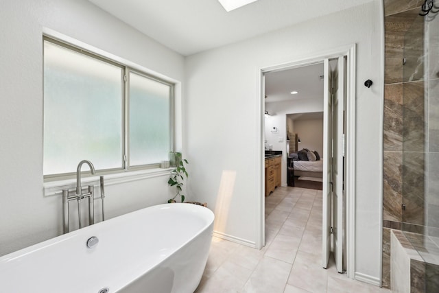 8820 Hunters Glen Trl, Fort Worth, TX 76120 - full bath featuring a soaking tub, connected bathroom, a tile shower, tile patterned floors, and a skylight