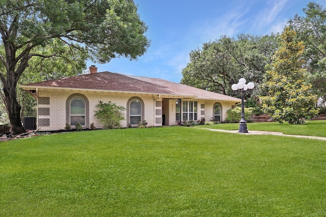 8820 Hunters Glen Trl, Fort Worth, TX 76120 - single story home featuring a front lawn, a chimney, and brick siding