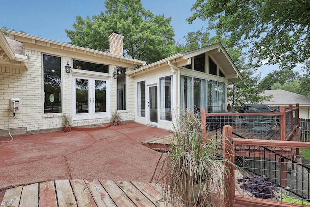 8820 Hunters Glen Trl, Fort Worth, TX 76120 - back of property featuring a chimney, french doors, a sunroom, and a patio area